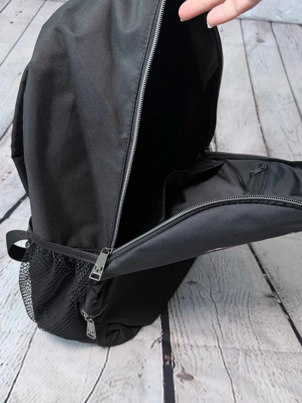 Black Messi backpack with graphic of a soccer player in action